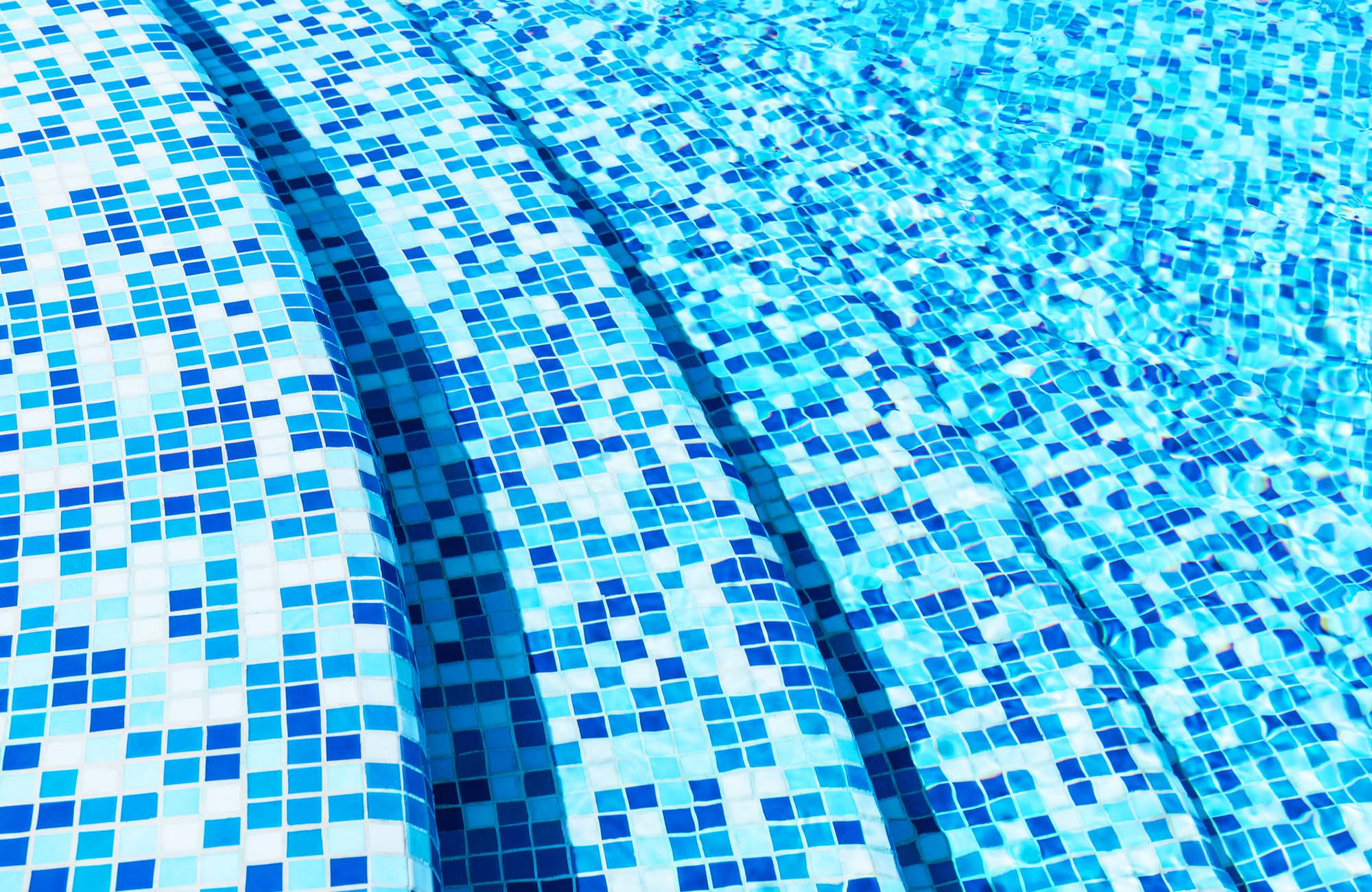 Creative abstract summer holidays, vacations and recreational activity concept background: macro view of blue tiled stone steps in swimming pool water spa resort