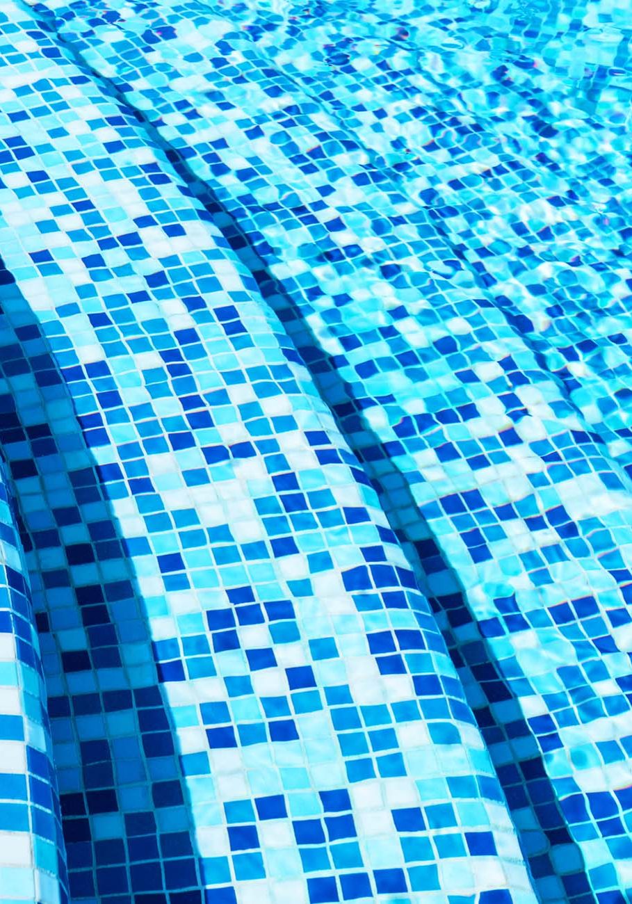 Creative abstract summer holidays, vacations and recreational activity concept background: macro view of blue tiled stone steps in swimming pool water spa resort
